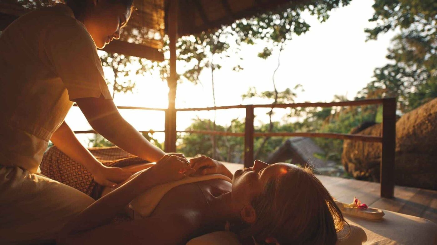 A therapist giving a guest a Taoist abdominal massage at Kamalaya, Koh Samui