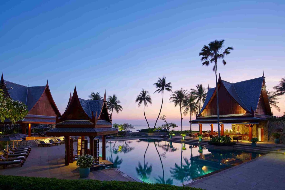 Thai-style pavilions and a reflecting pool at Chiva-Som in Hua Hin at dusk