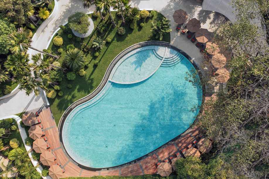 Aerial view of the pool and tropical gardens at Mövenpick BDMS Wellness Resort Bangkok